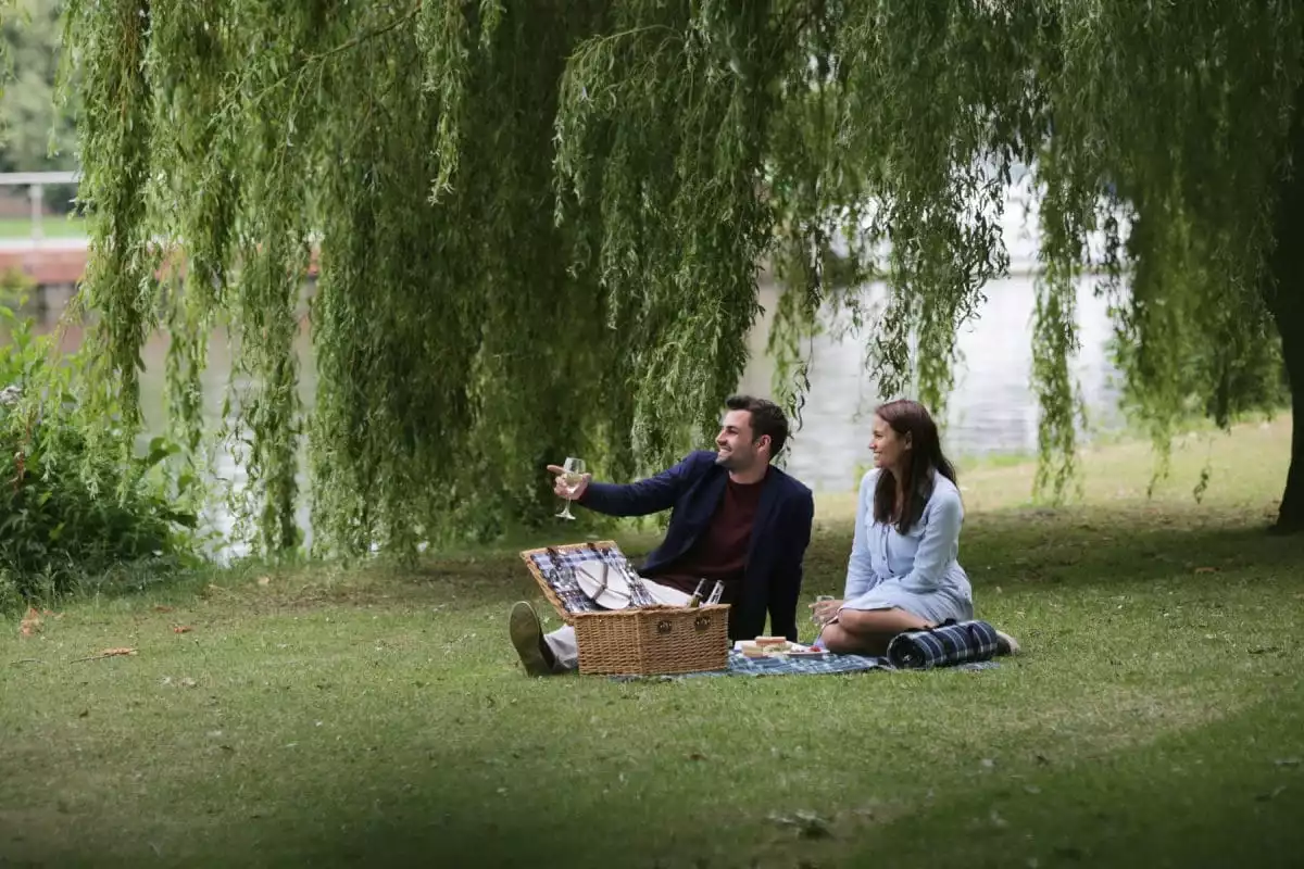 couple having a picnic in grounds, runnymede on thames