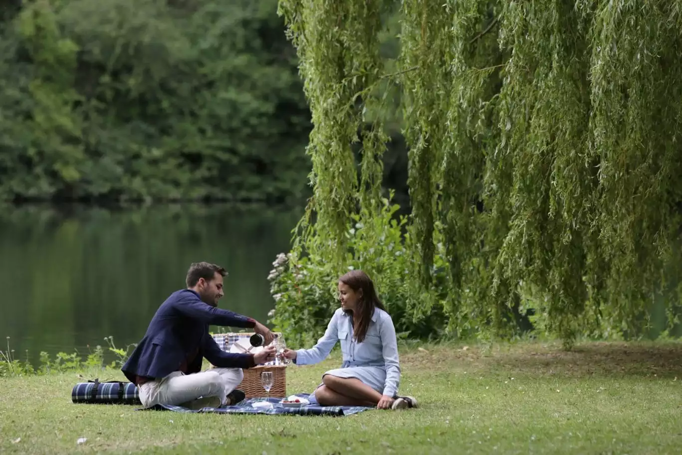 couple having a picnic in the grounds, runnymede on thames