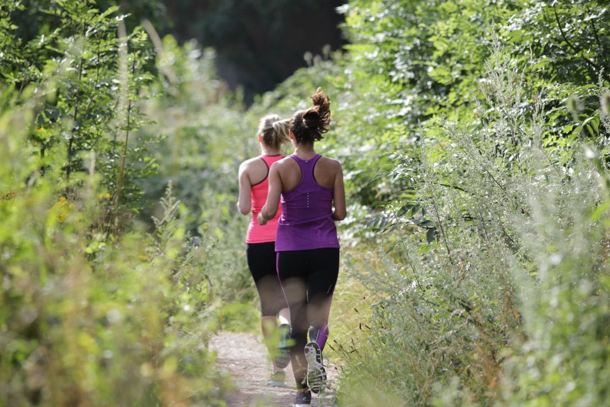 two women out running on the towpath, runnymede on thames