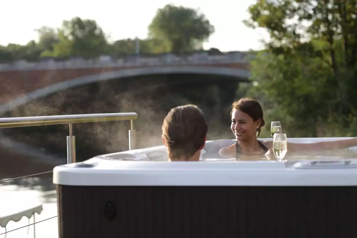 Couple in the Whirlpool on the Weir drinking Champagne